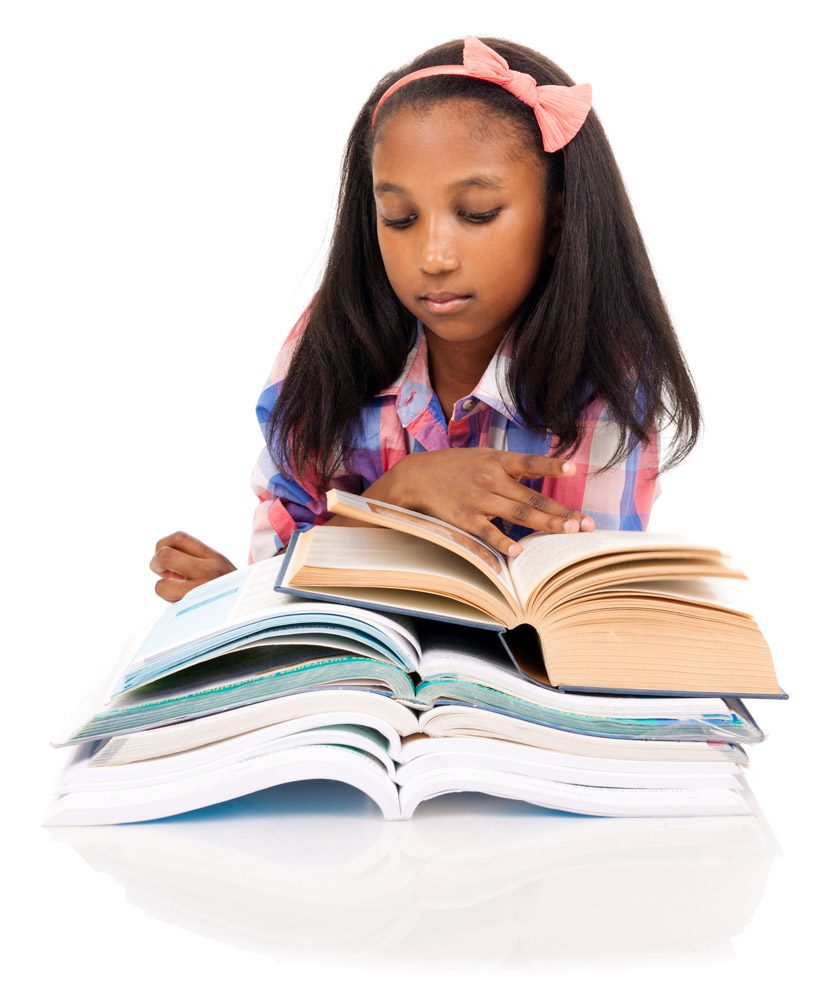 Girl with a pink hair bow reading an open book atop a tall stack of books