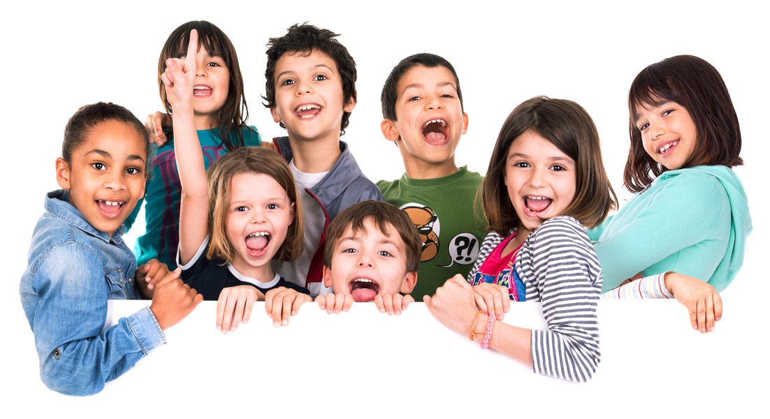 A group of excited, laughing children peeking over a white board
